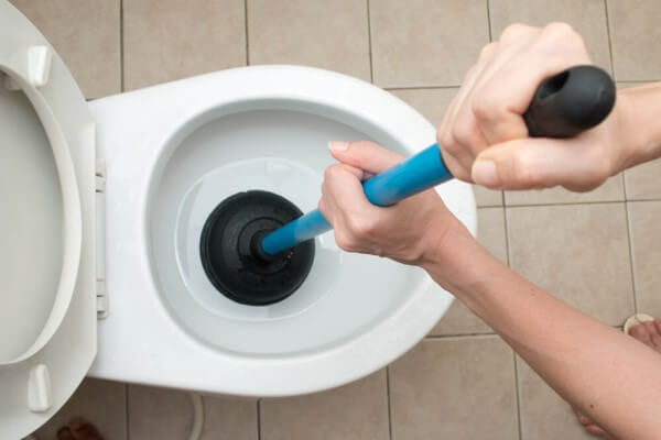 Using a plunger to unblock a toilet